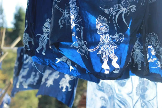 Indigo batik textiles hanging outdoors after the wax-resist dyeing process