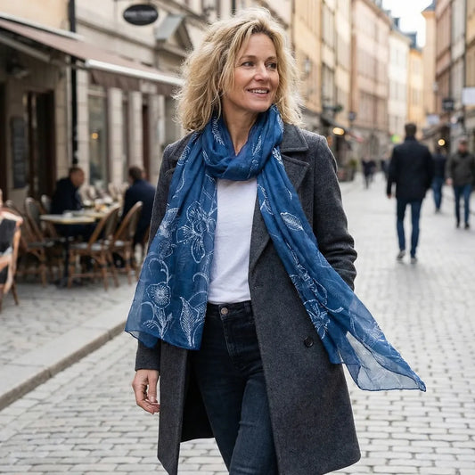 Woman wearing a miao batik silk scarf and gray coat on a city street