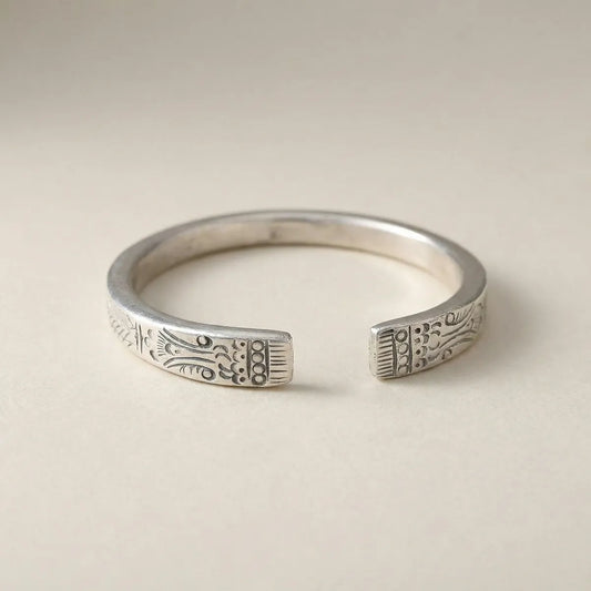 Miao Silver ring with intricate designs on a beige background