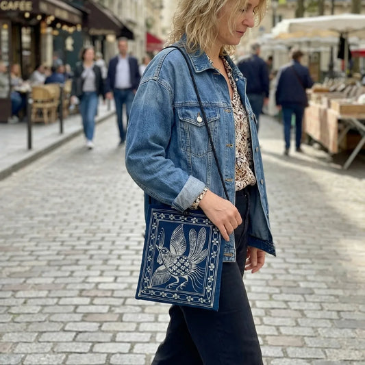 Woman holding a Miao batik bag on a street