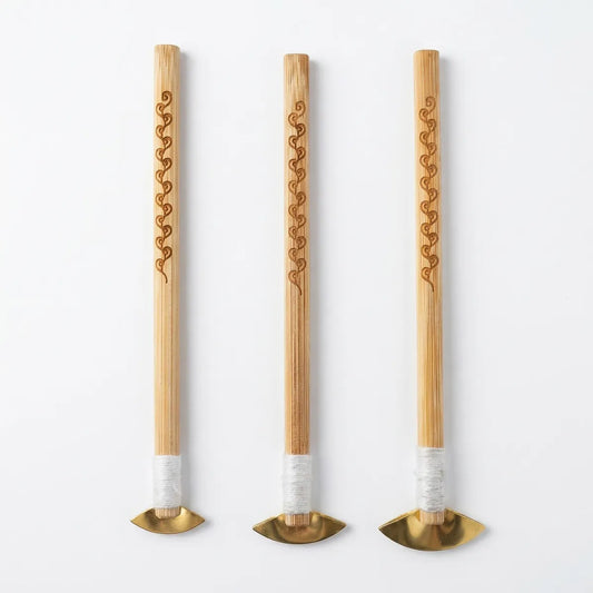 Three wooden Miao Batik wax knife with gold tips and white handles on a white background