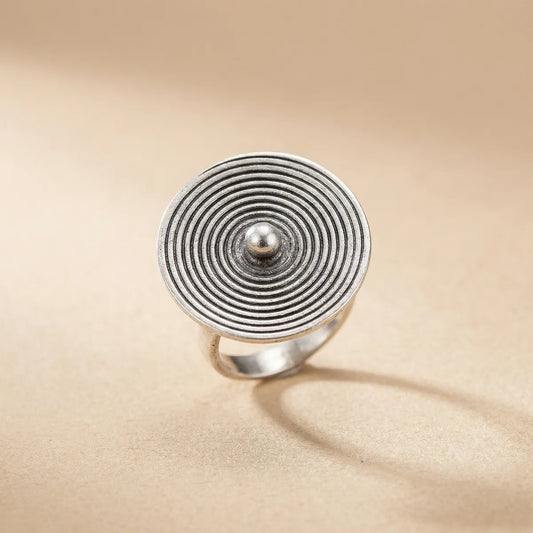 Miao Silver ring with concentric circle design on a beige background
