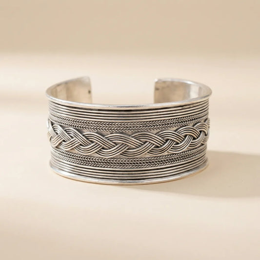 Miao Silver braid patterned cuff bracelet on a beige background