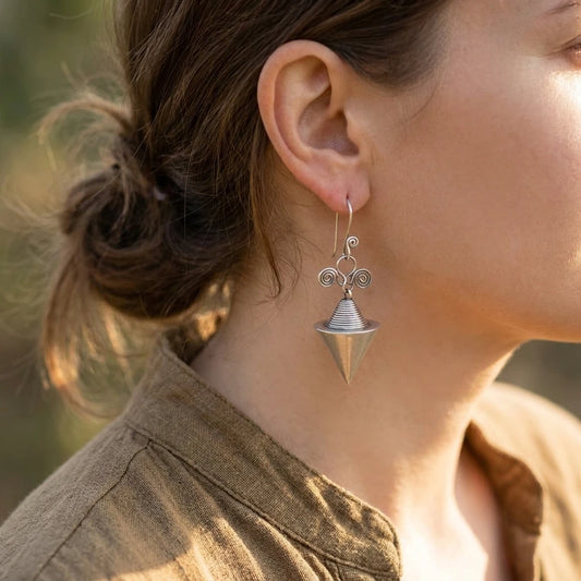 Miao Silver Hollow Cone Earrings worn for scale