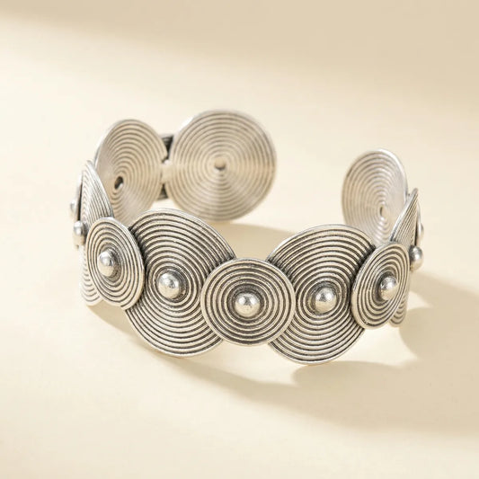 Miao Silver bracelet with circular design on a beige background