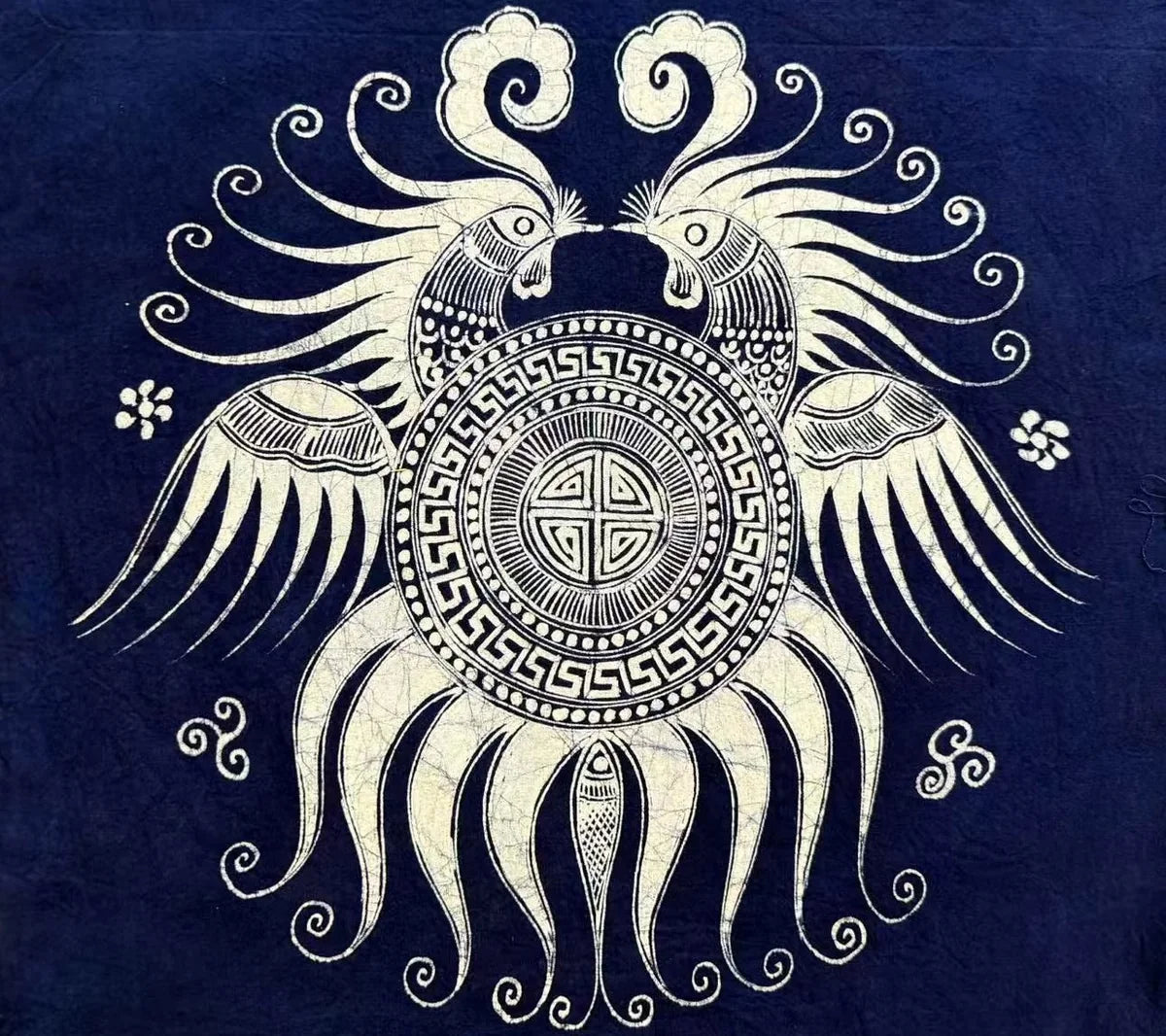 Circular Miao batik bird motif with dense white linework on indigo cloth