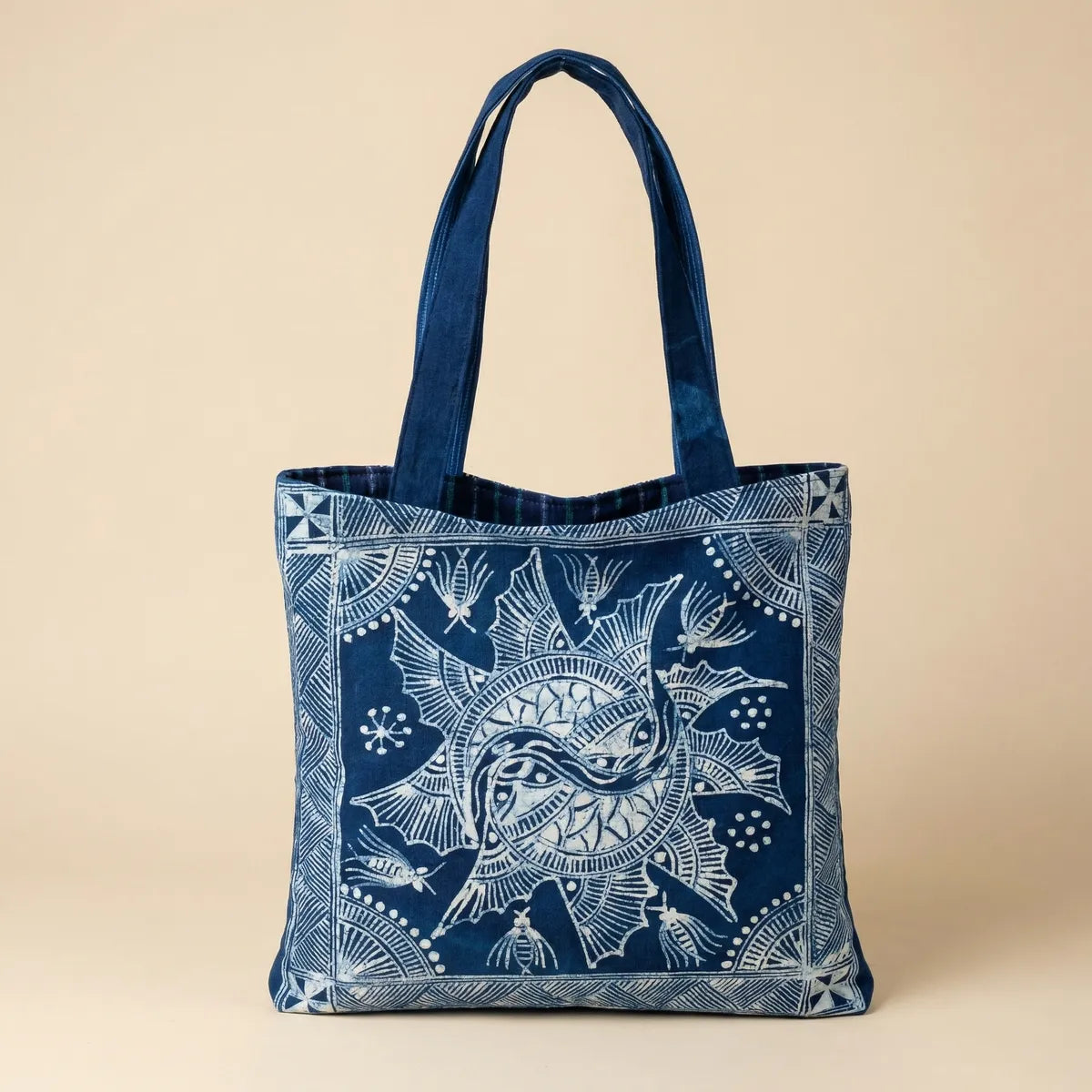 Miao batik tote bag with white patterns on a beige background