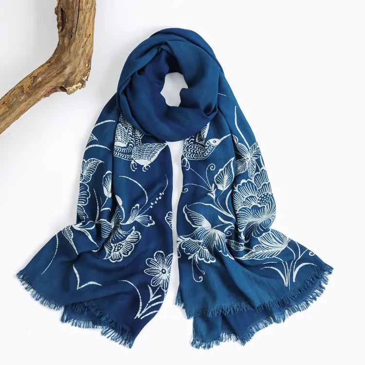 Blue Miao batik scarf with white floral patterns on a white background