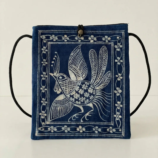 Miao batik crossbody bag with white bird design on a light background