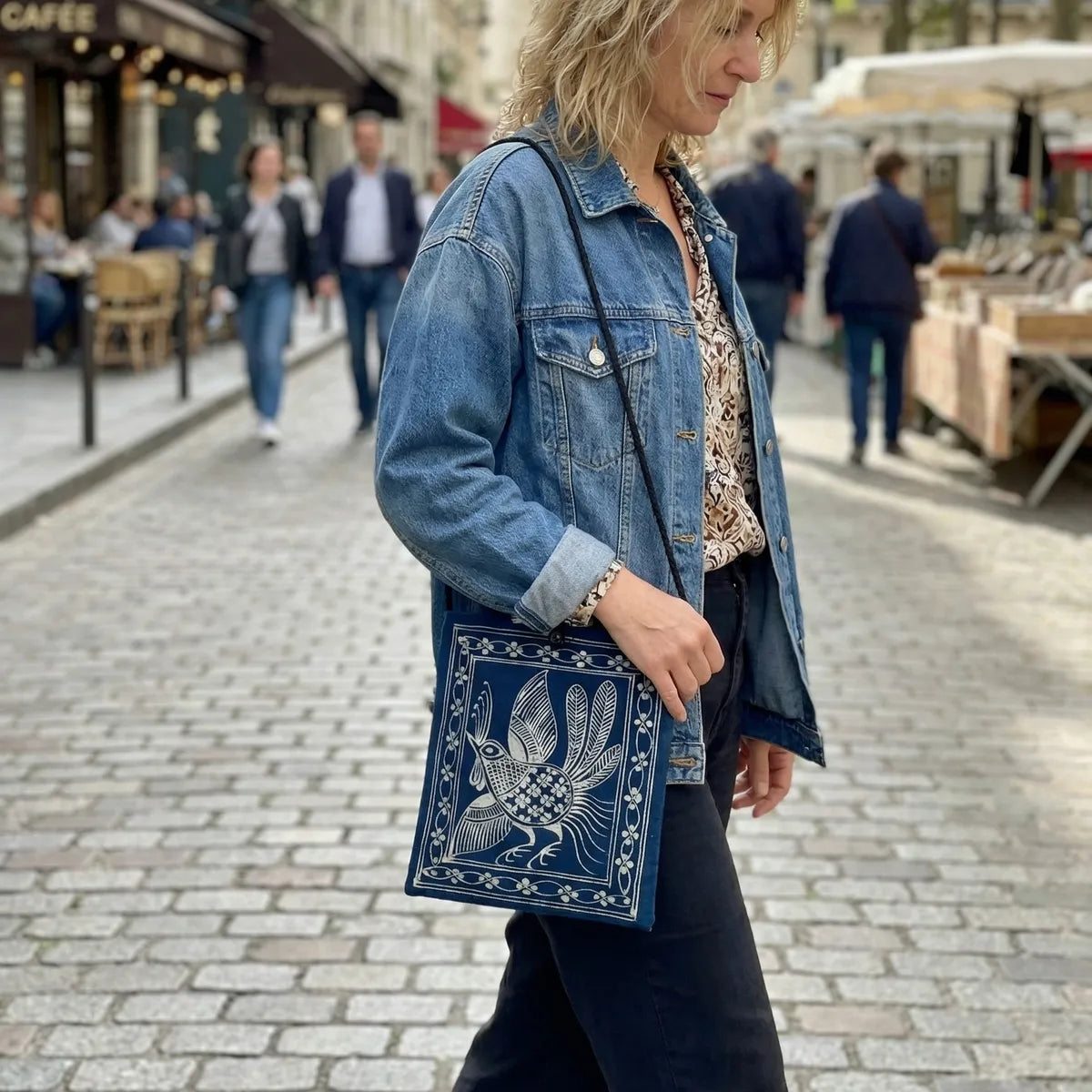 Woman holding a Miao batik bag on a street