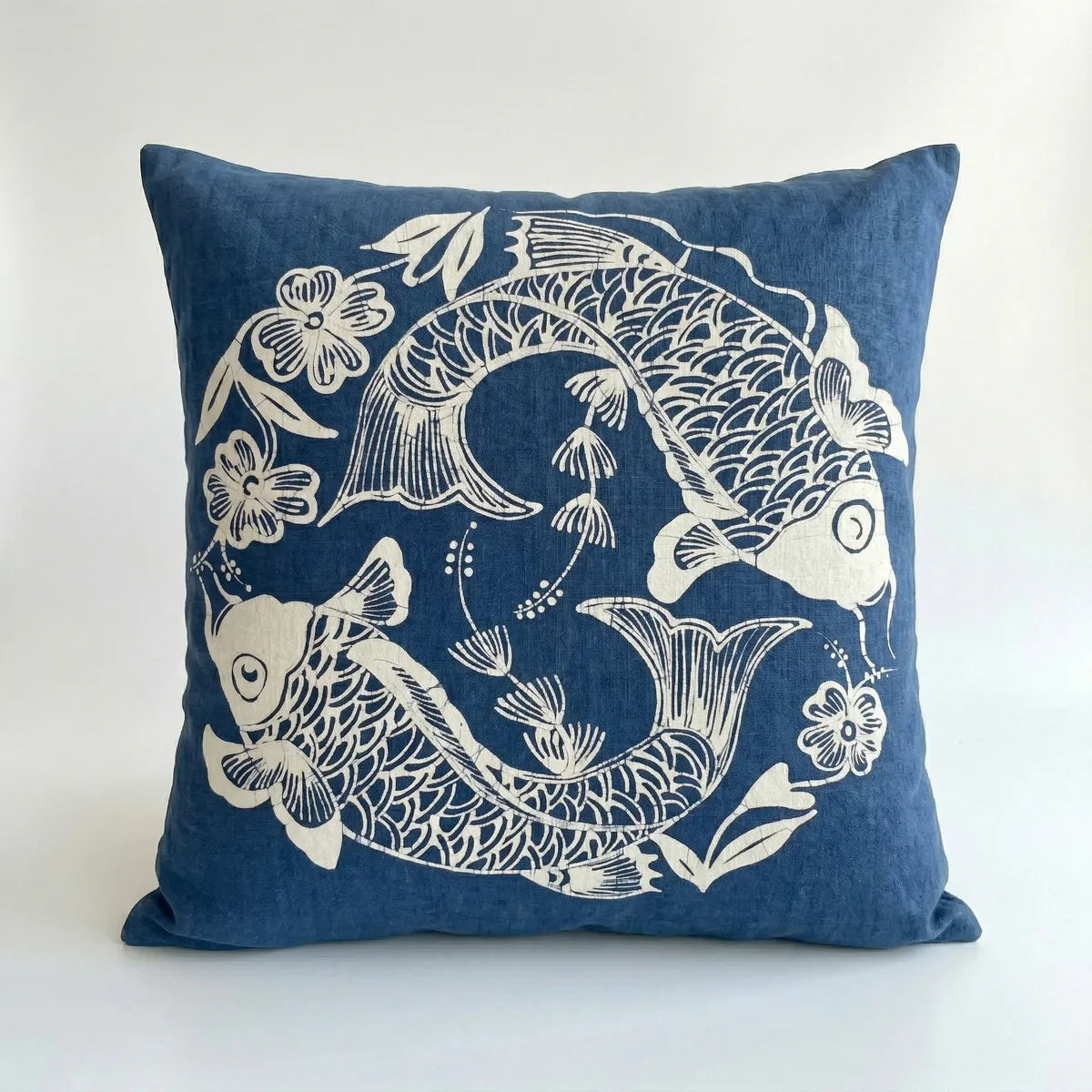 Miao batik pillow with white koi fish and floral designs on a white background