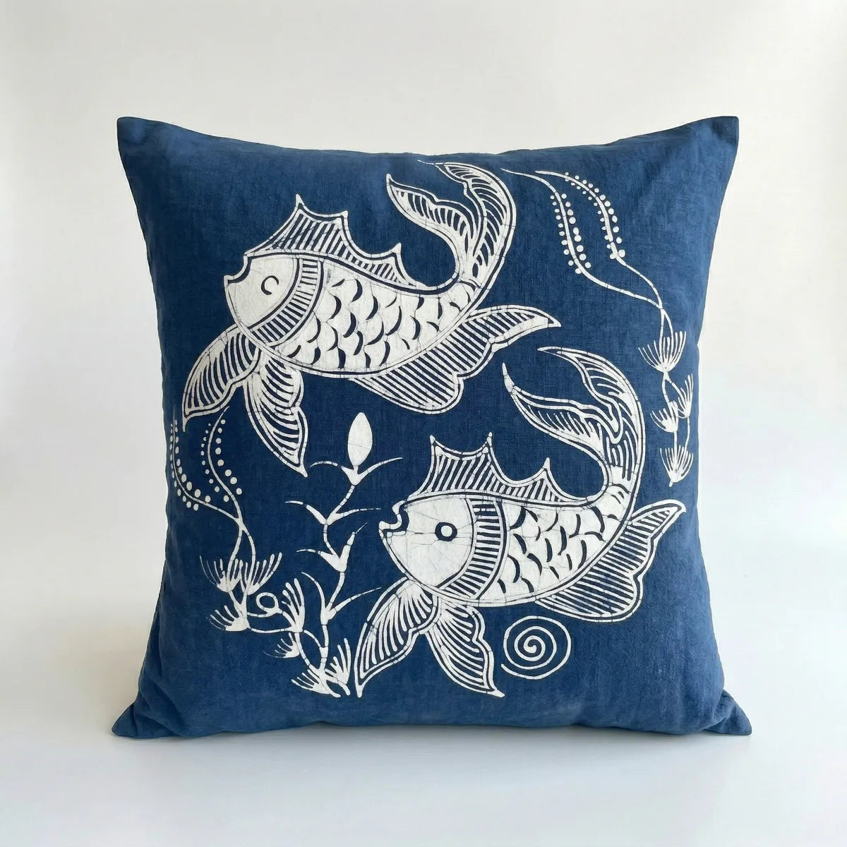 Miao batik pillow with white fish design on a white background