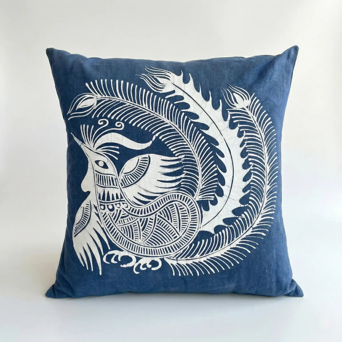 Miao batik pillow with white decorative design on a white background