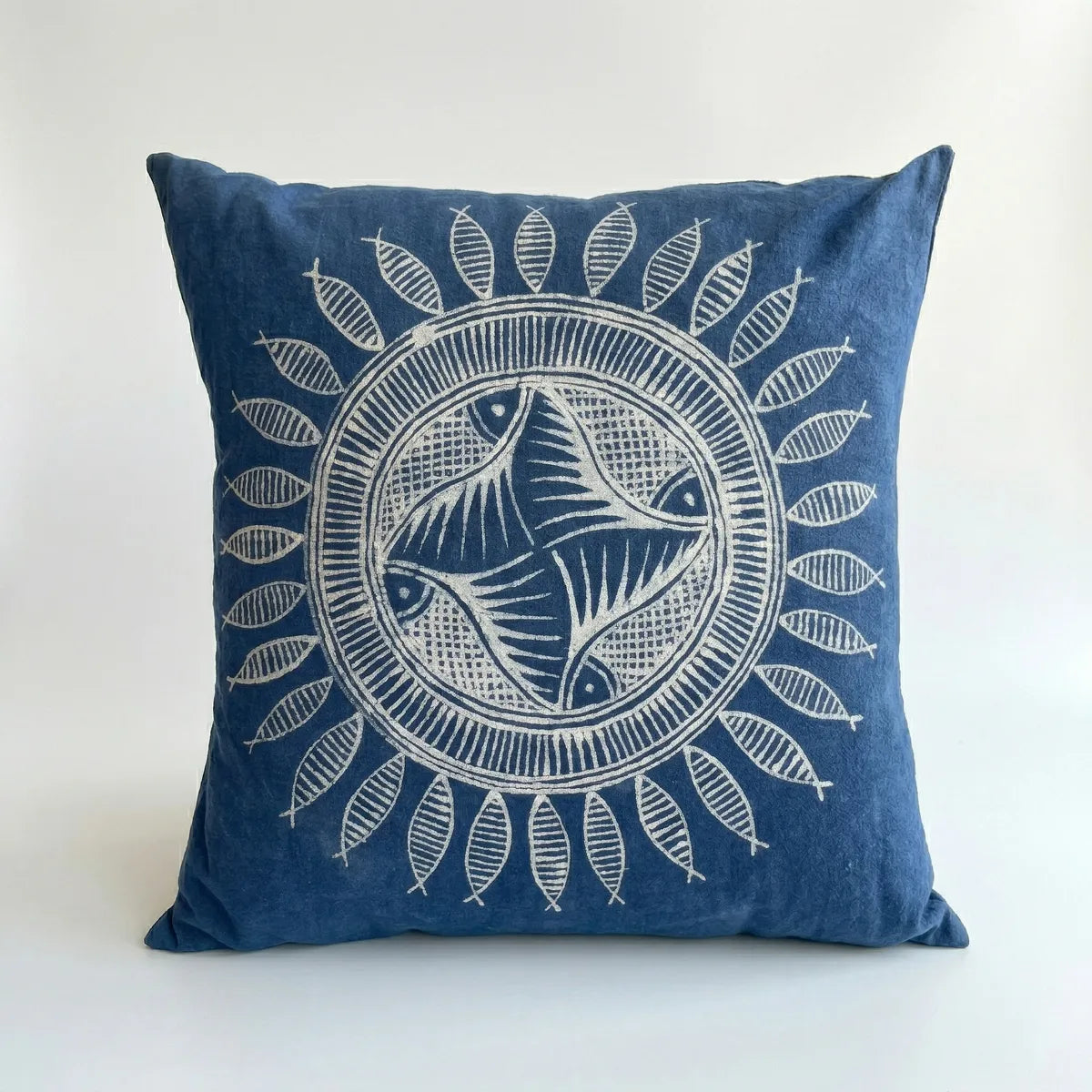 miao batik pillow with white fish and sun design on a white background