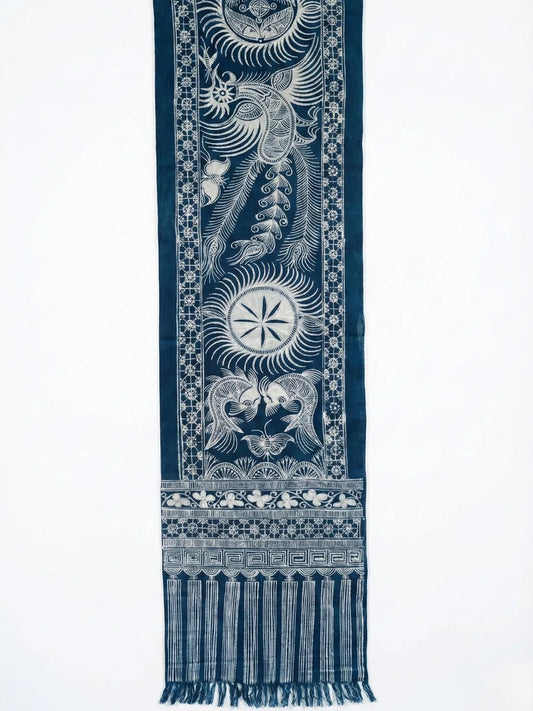 Blue Miao batik table runner with white intricate patterns on a white background