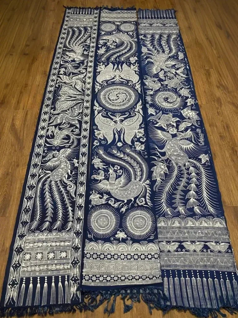 Decorative blue and white patterned miao batik tapestry on a wooden floor