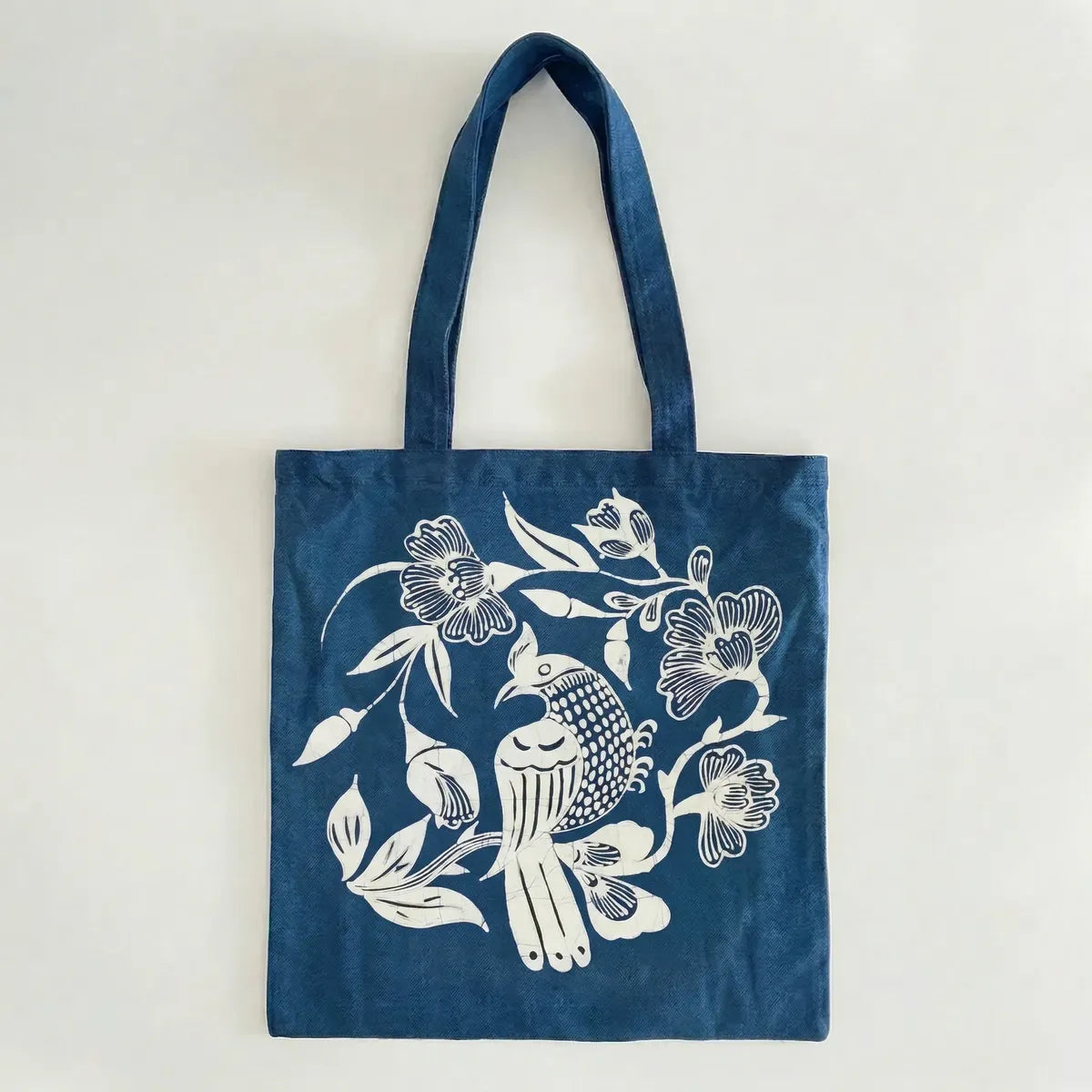 Miao batik  tote bag with white floral and bird design on a light gray background