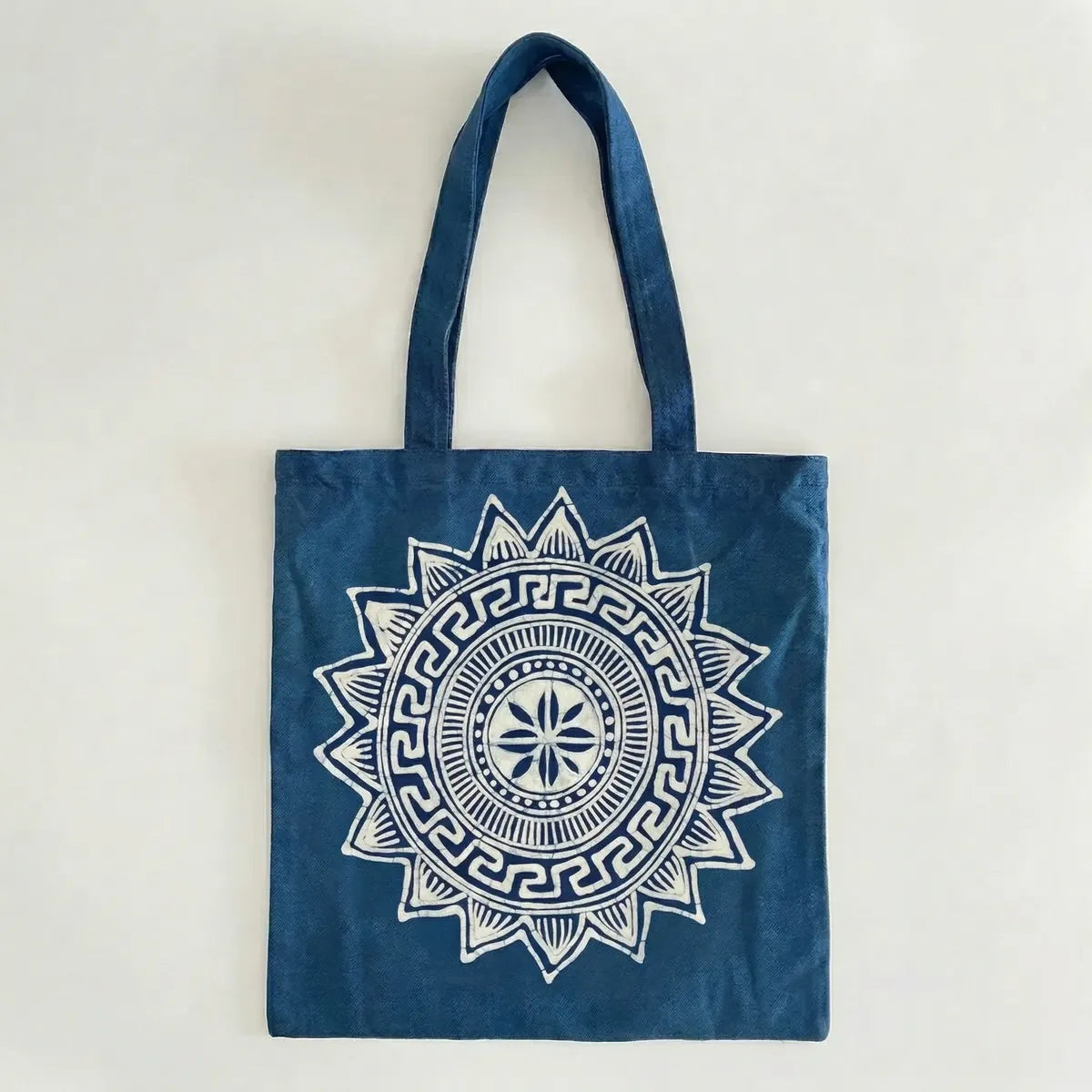 Miao batik tote bag with a white mandala design on a light gray background