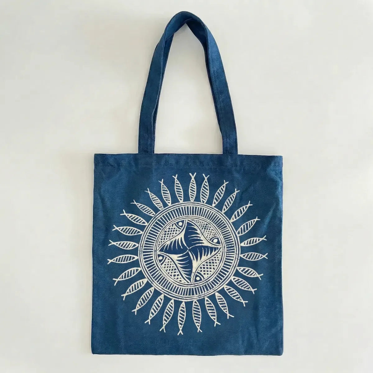 Miao batik tote bag with white fish design on a light gray background