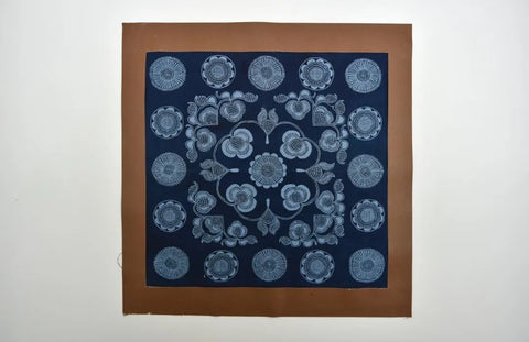 Framed Miao batik textile with white motifs on indigo fabric