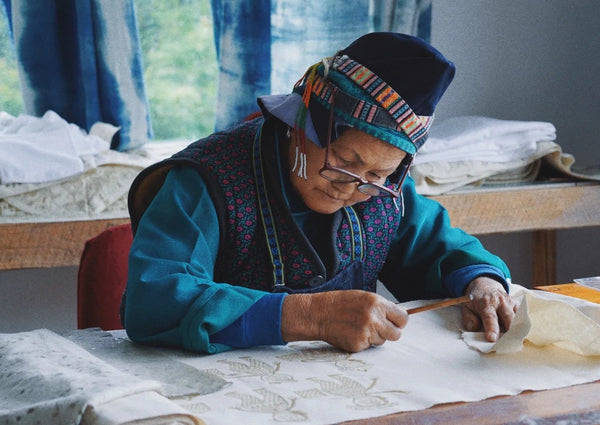Miao artisans practicing batik wax drawing together