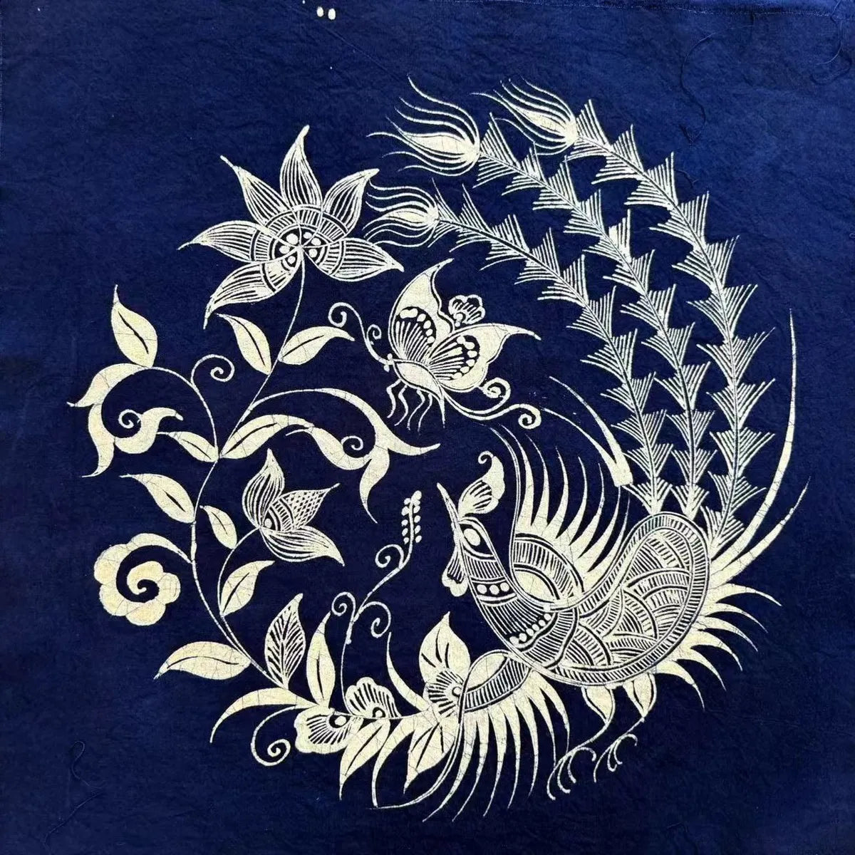 Decorative Miao batik fabric of a peacock and butterflies on a blue background