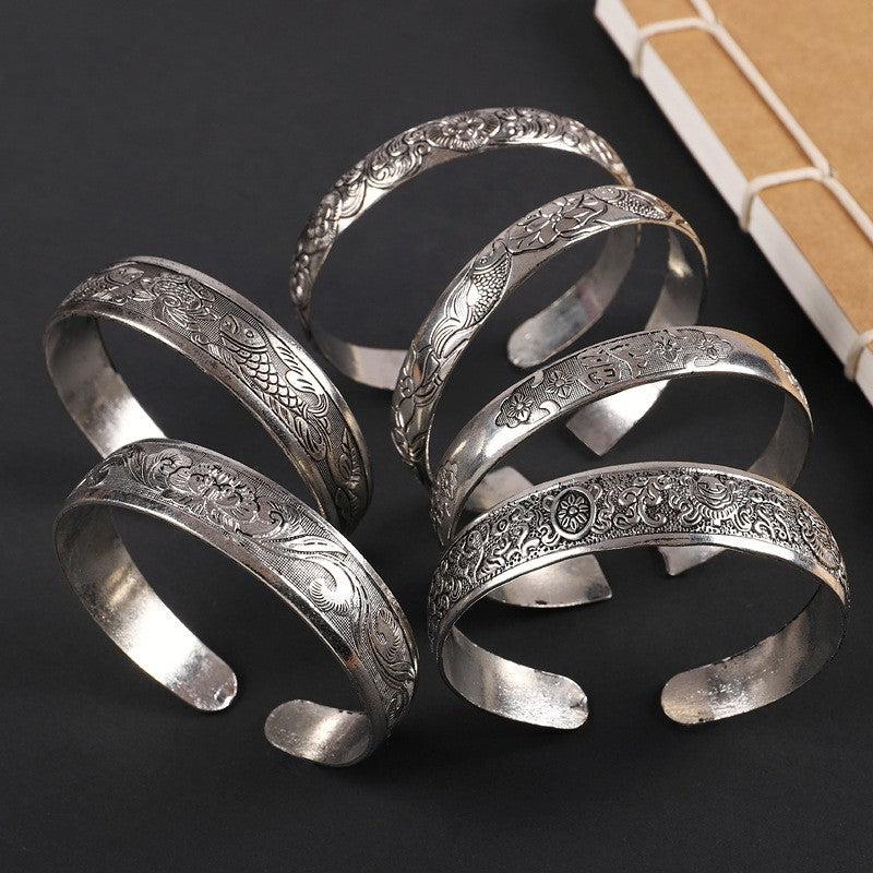 Handmade Miao silver bracelet with detailed raised motifs