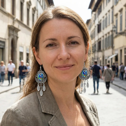 Woman with large earrings standing on a street with blurred people in the background