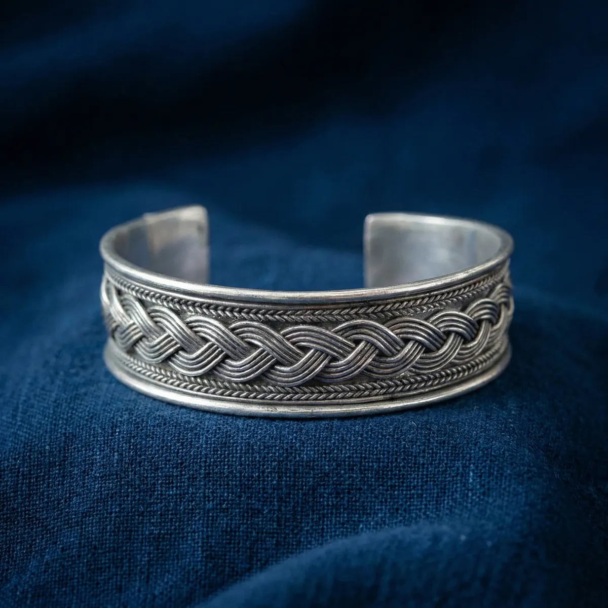 Miao Silver braided bracelet on a blue fabric background