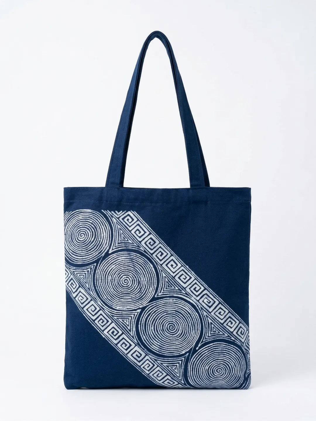 Navy Miaozu Batik tote bag with white circular pattern on a white background