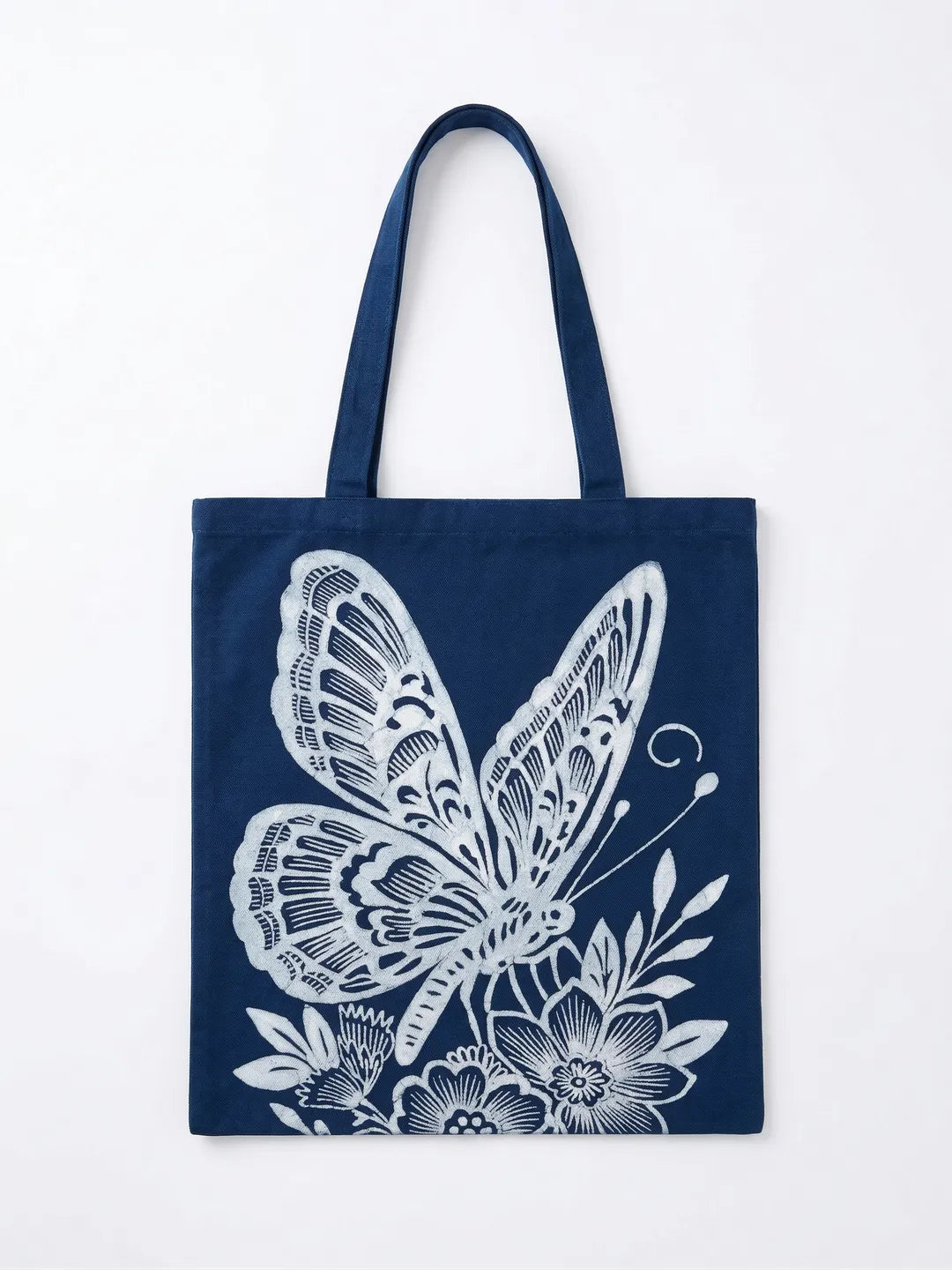 Miao batik tote bag with white butterfly and floral design on a white background