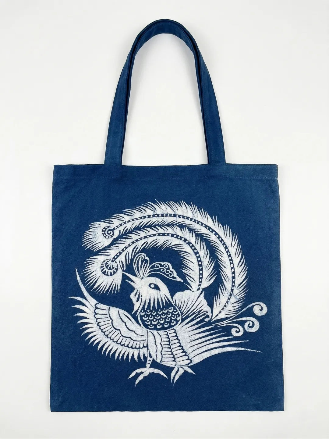 Navy Miaozu Batik tote bag with white bird and feather design on a white background