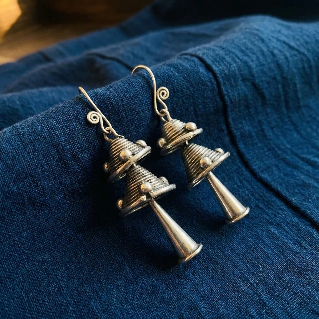 Miao Silver Double Bell Dangle Earrings – Short Double Bell displayed on indigo textile
