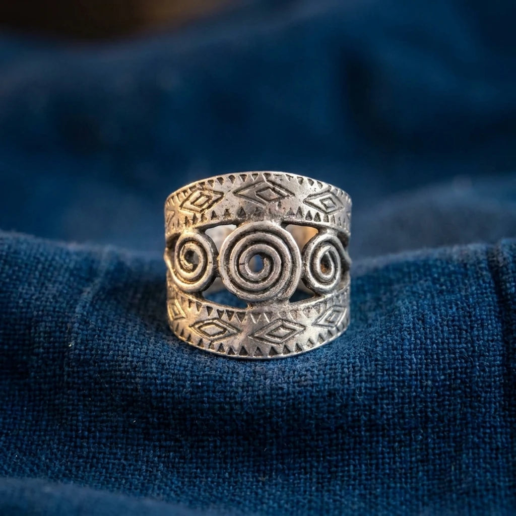 Miao Silver Engraved Spiral Band Ring displayed on indigo textile