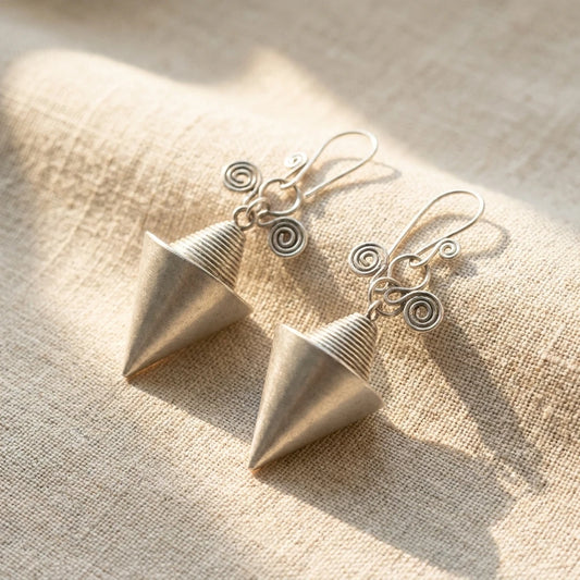 Miao Silver Hollow Cone Earrings on a light background