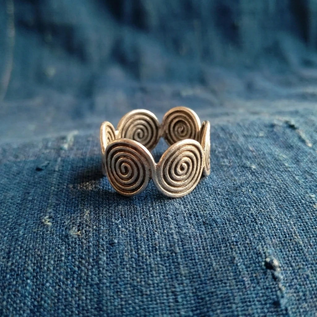 Miao Silver Six-Circle Adjustable Ring displayed on indigo textile