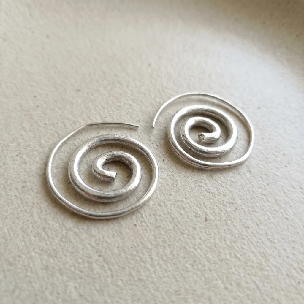 Miao Silver Spiral Stud Earrings on a light background