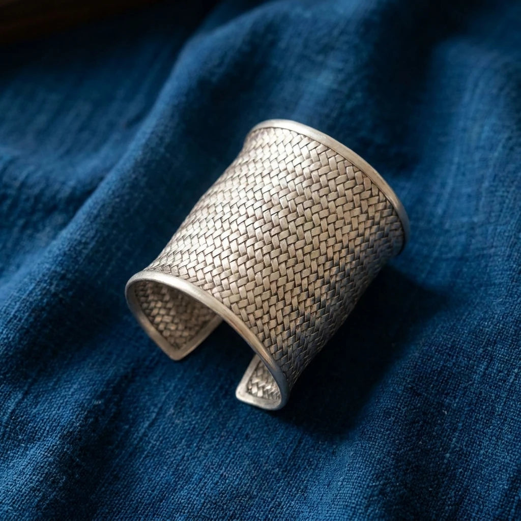 Miao Silver Woven Open Cuff Bracelet – 5 cm displayed on indigo textile